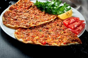 lahmacun-is-popular-turkish-dish-thin-crispy-tortilla-with-minced-lamb-tomatoes-bell-pepper-black-table